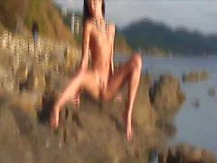 Cute Russian brunette is on the beach naked and posing for camera