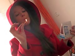 Cute girl smokes with her big natural boobs out
