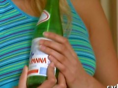 Thin blonde teen masturbates with a bottle