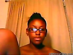 Cute ebony teen with glasses fingers her pussy on webcam